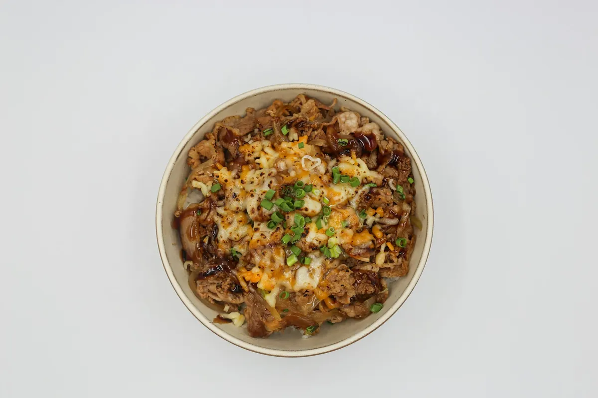 Sliced sausage steamed on top of rice