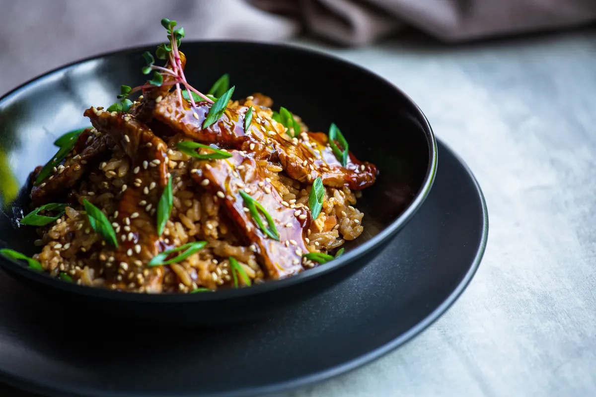 A dark savory sauce simmering in a wok