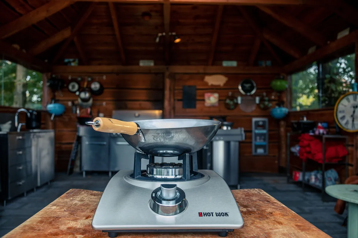 A seasoned wok heating on a burner