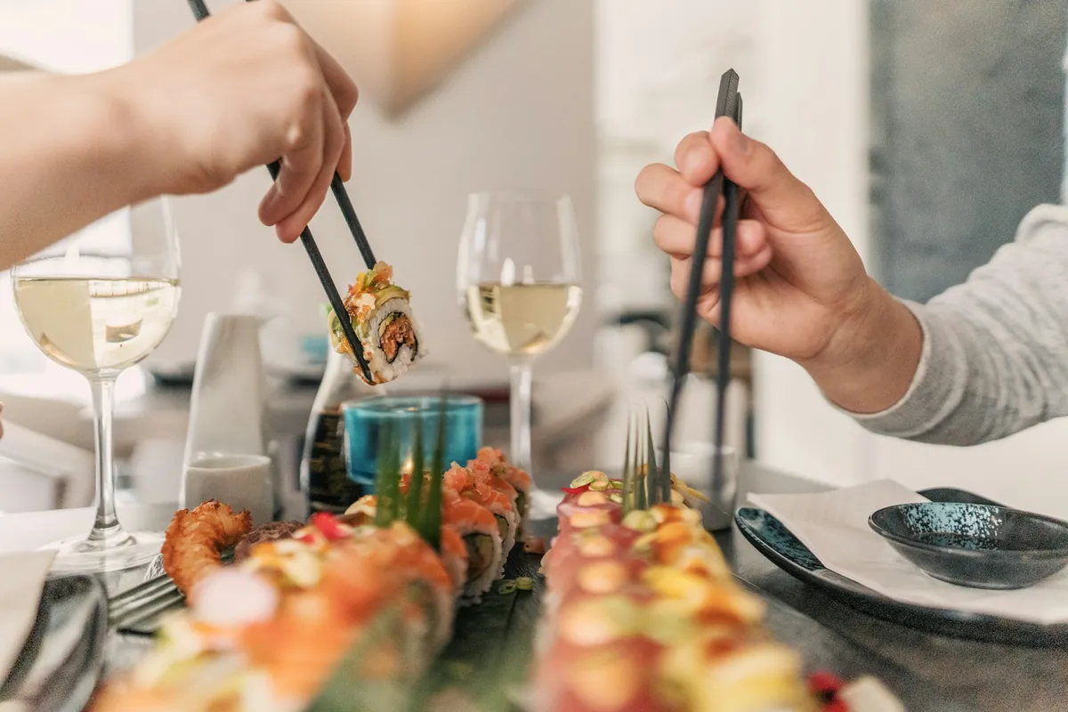 People serving themselves from shared dishes