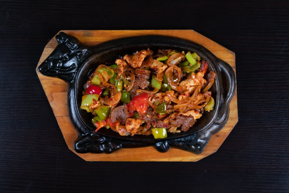 Several proteins cooking together in one pan