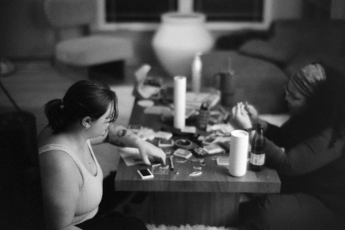 People sharing fried dough at a table