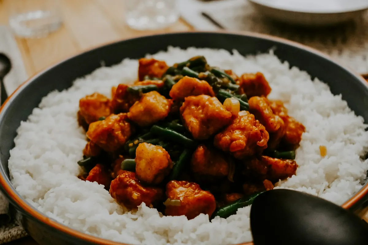 Sliced cooked chicken breast in a stir-fry