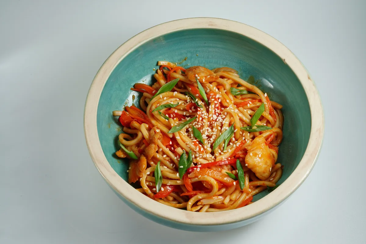 Thick soft wheat noodles coated in a glossy sauce