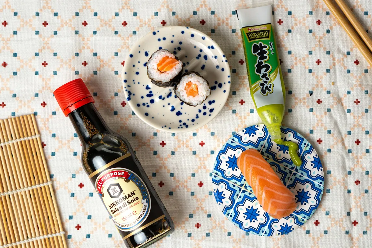 A bottle of soy sauce beside a small dish