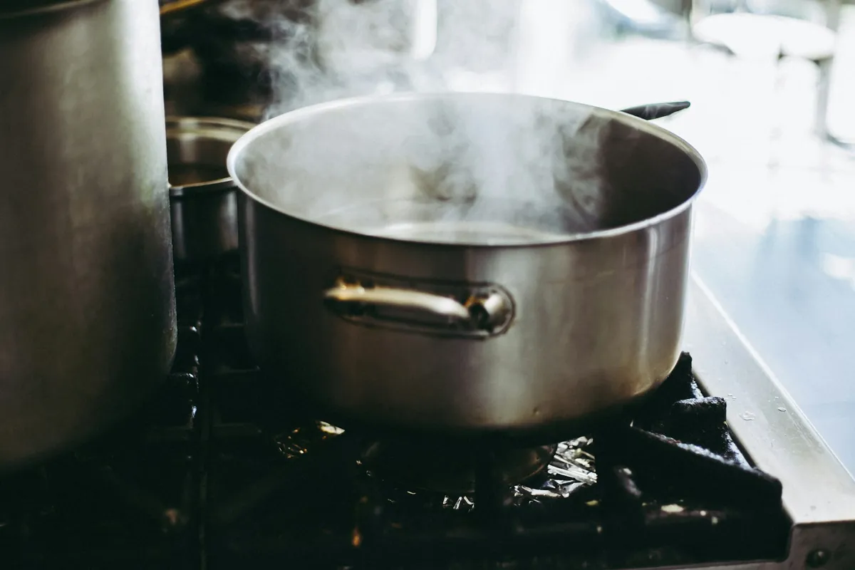 Spices being added to a braise