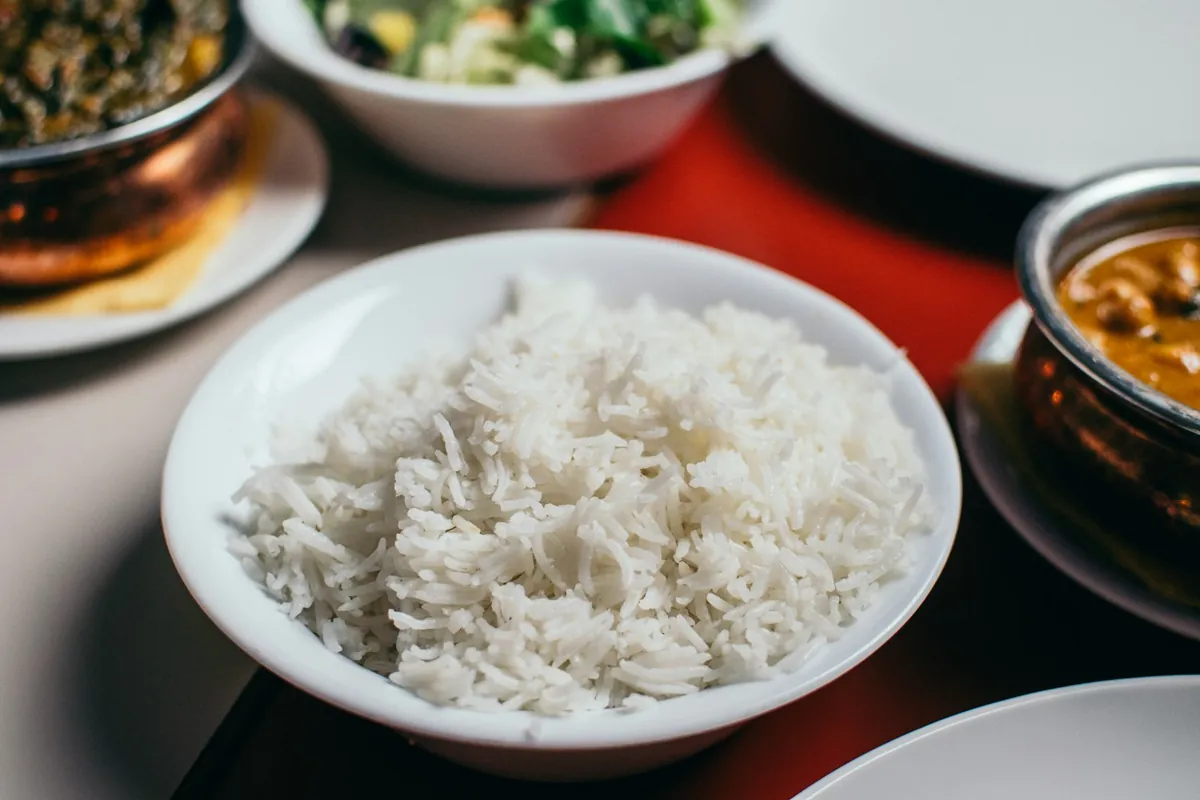 A savory stir-fry served over a bowl of steamed white rice