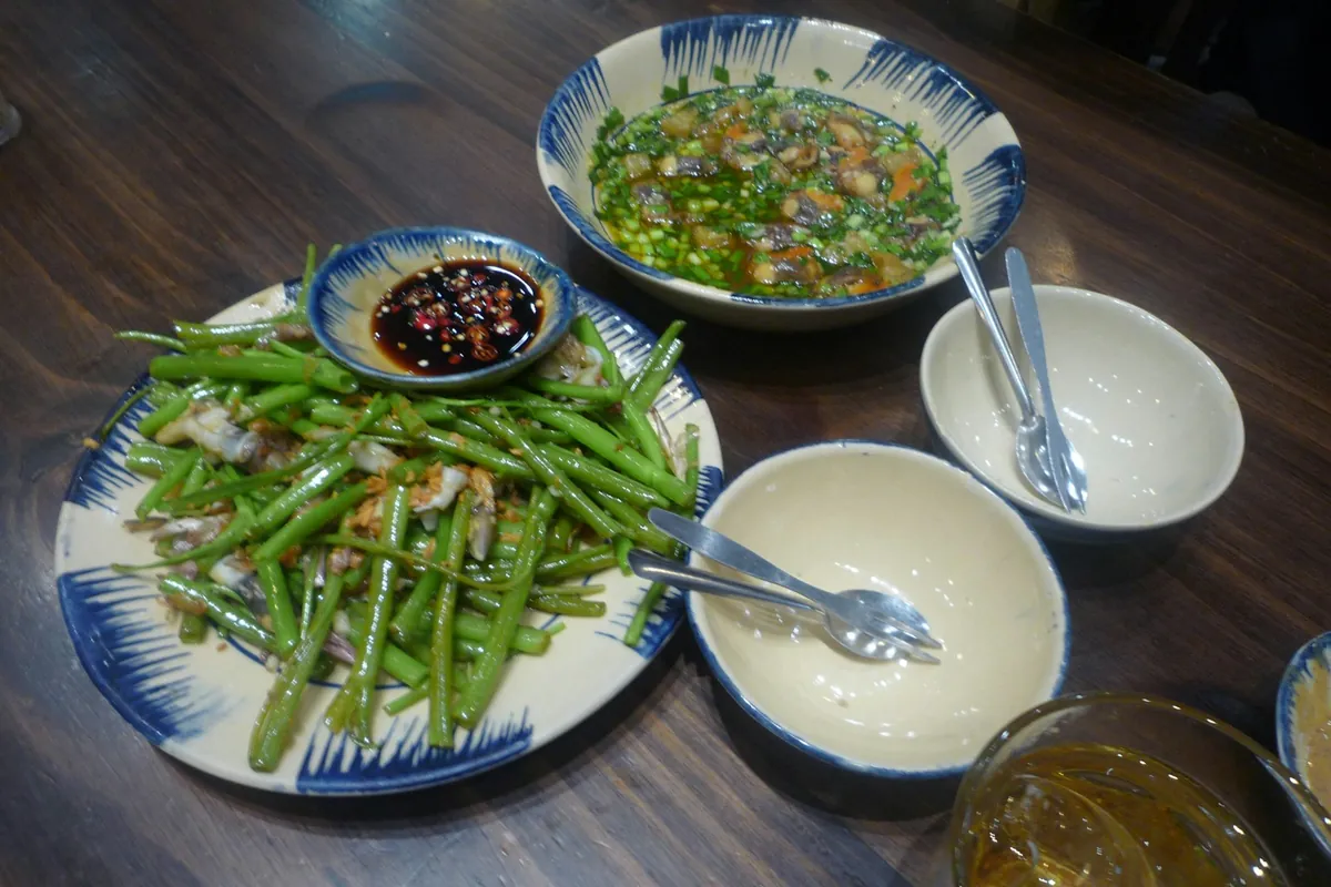 A small bowl of red-orange dipping sauce beside fried food