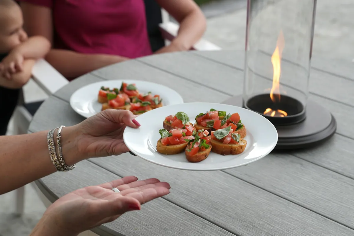 A small burner flame on a dining table