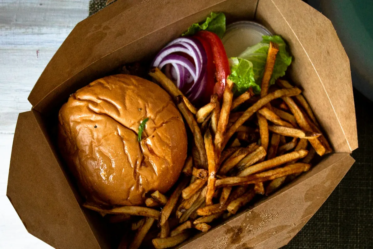 A paper takeout bag containing a food order