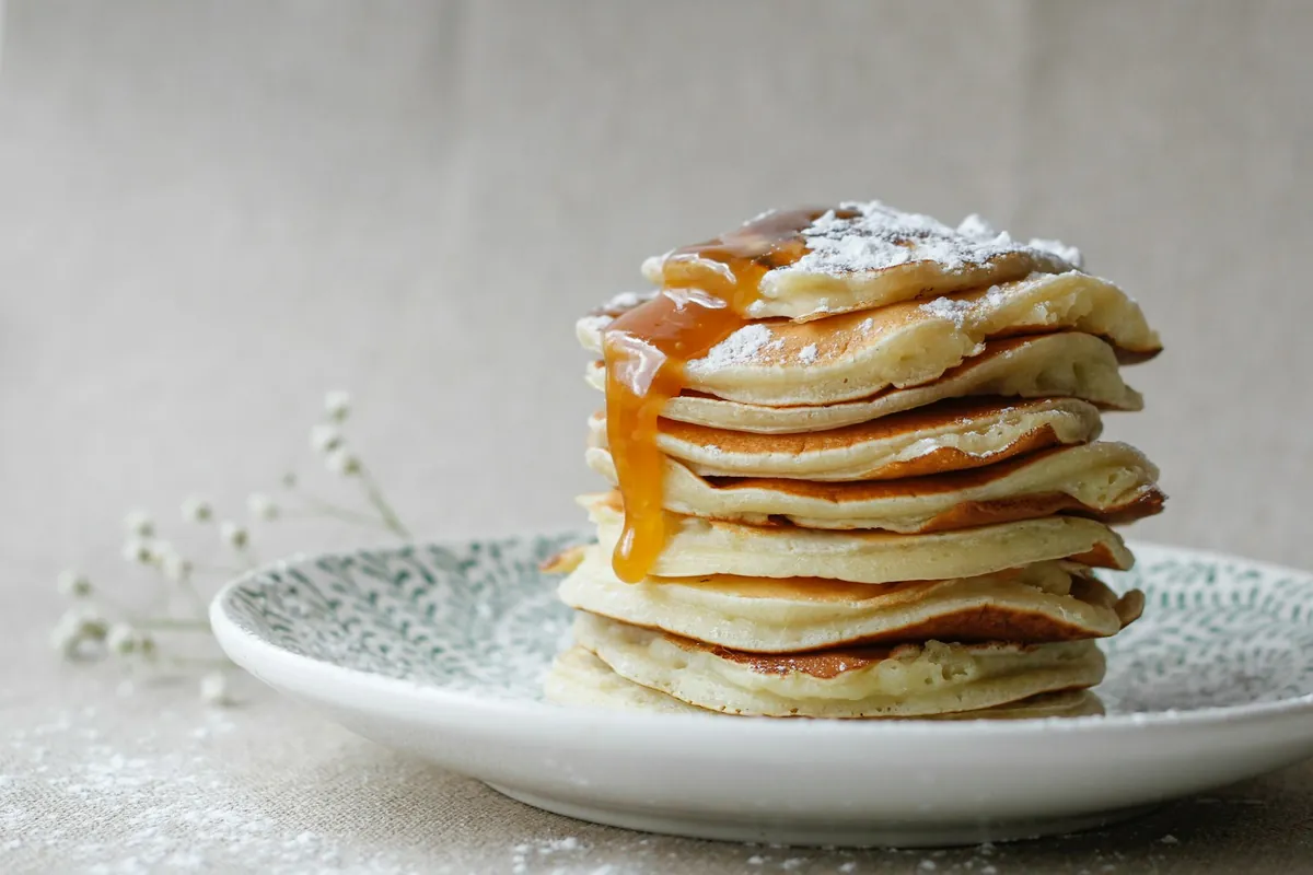 Thin soft flour pancakes stacked on a plate