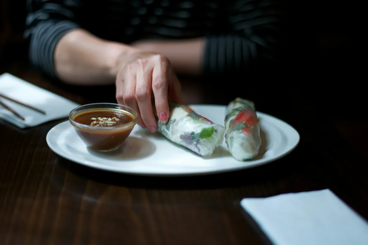 Slim spring rolls served with a dipping sauce