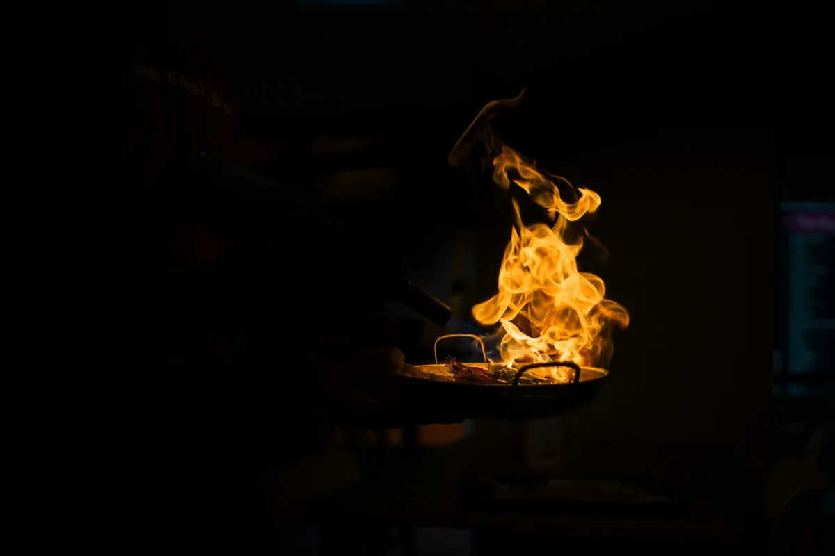 Chicken being tossed in sauce in a wok