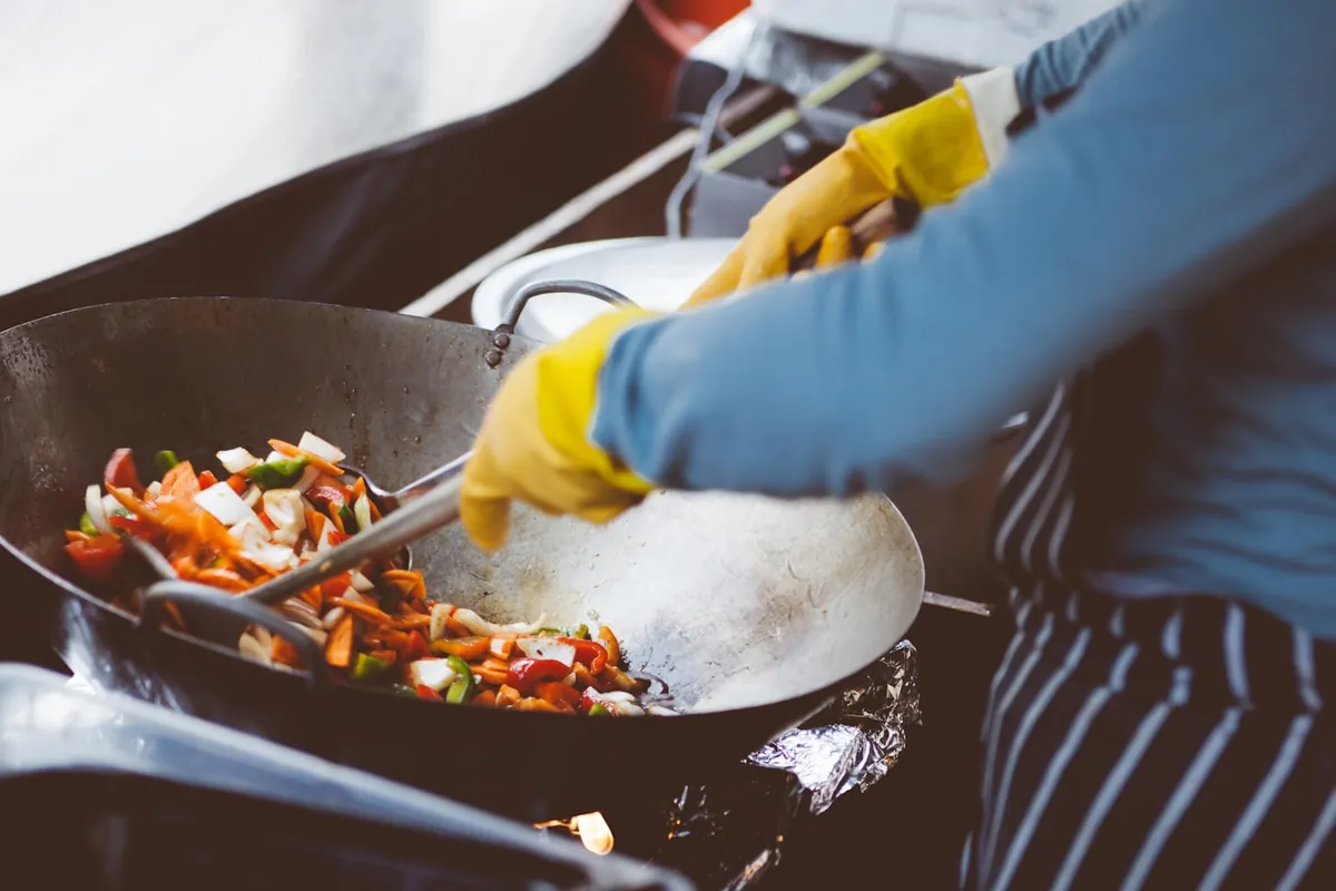 Vegetables being tossed in a hot wok