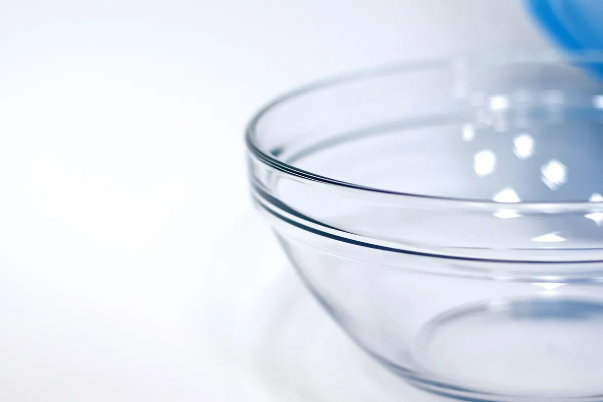 Dark vinegar being poured into a dish