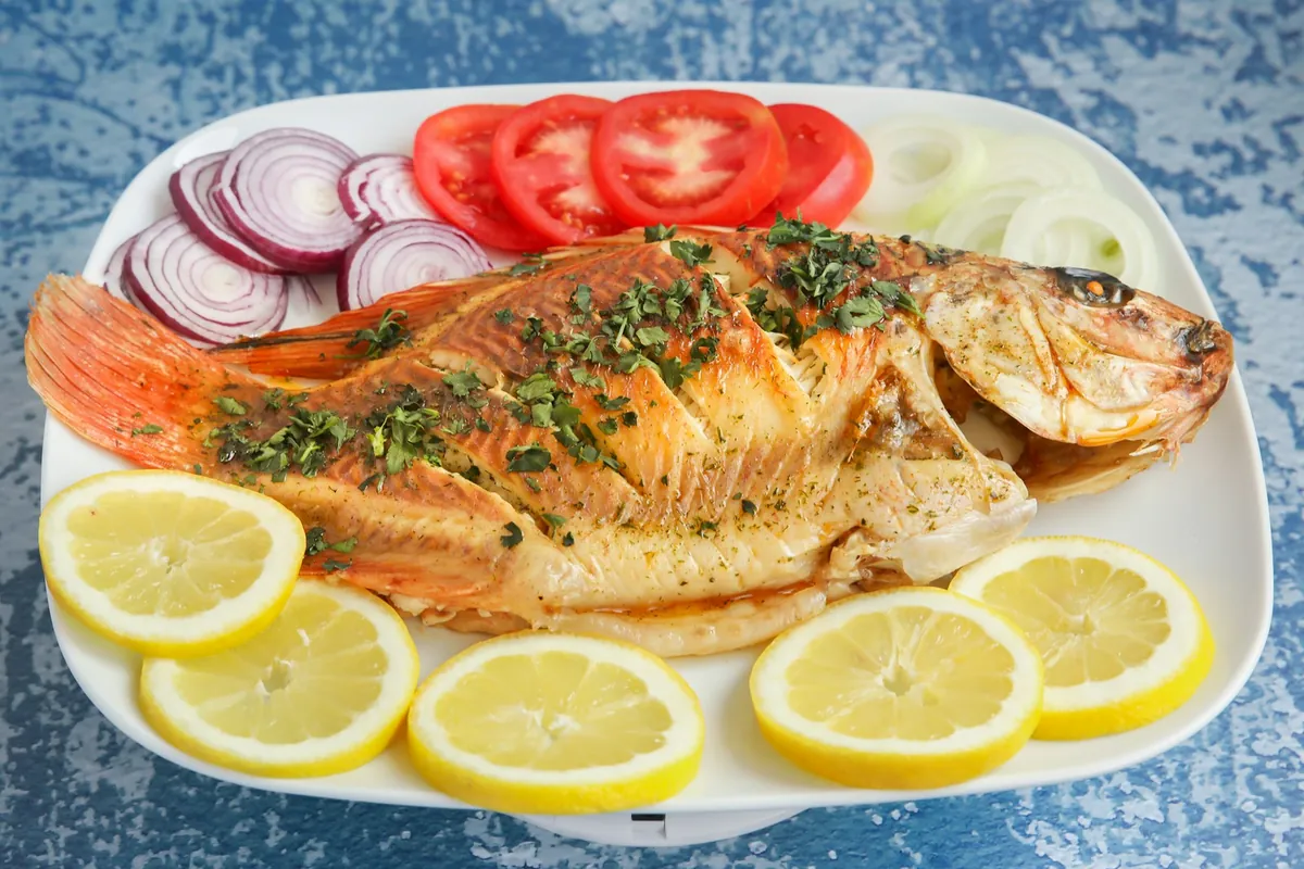 A whole steamed fish served on a platter