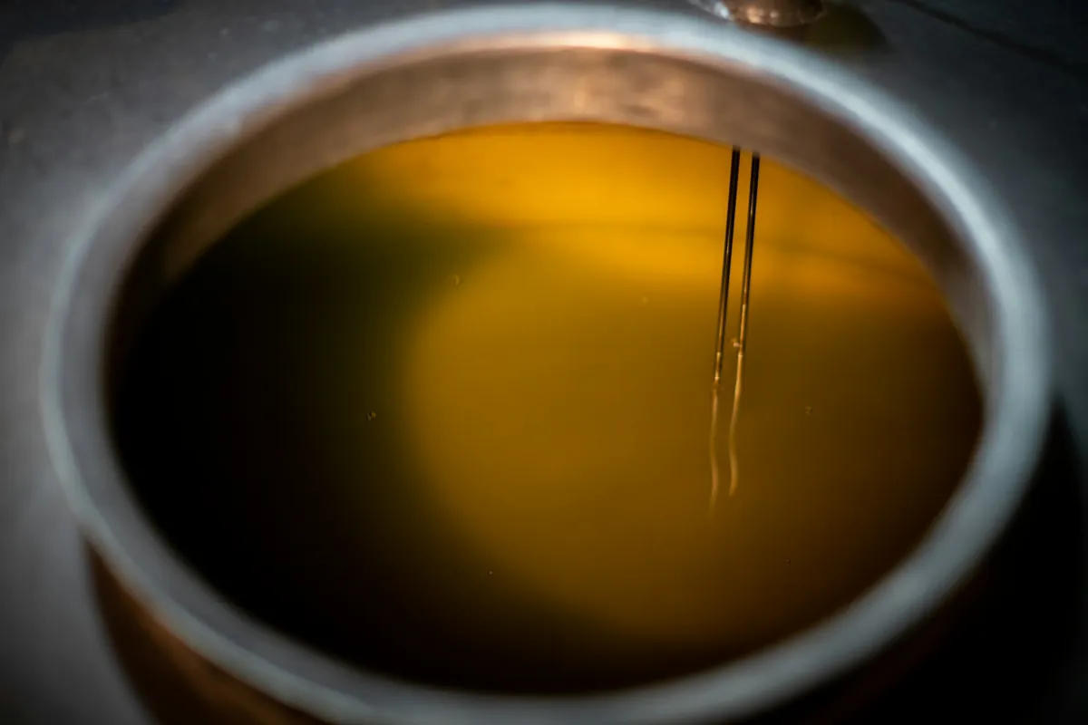 Liquid being added around the edge of a hot pan