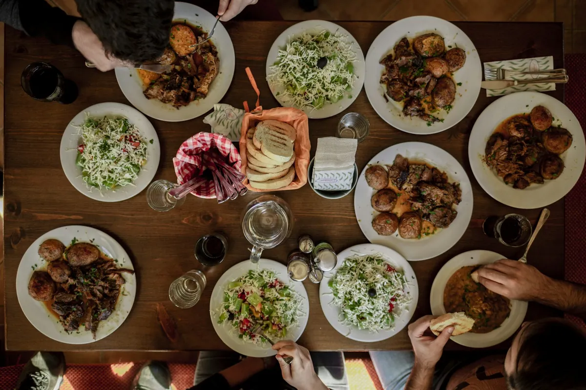 People sharing a platter of wings at a table