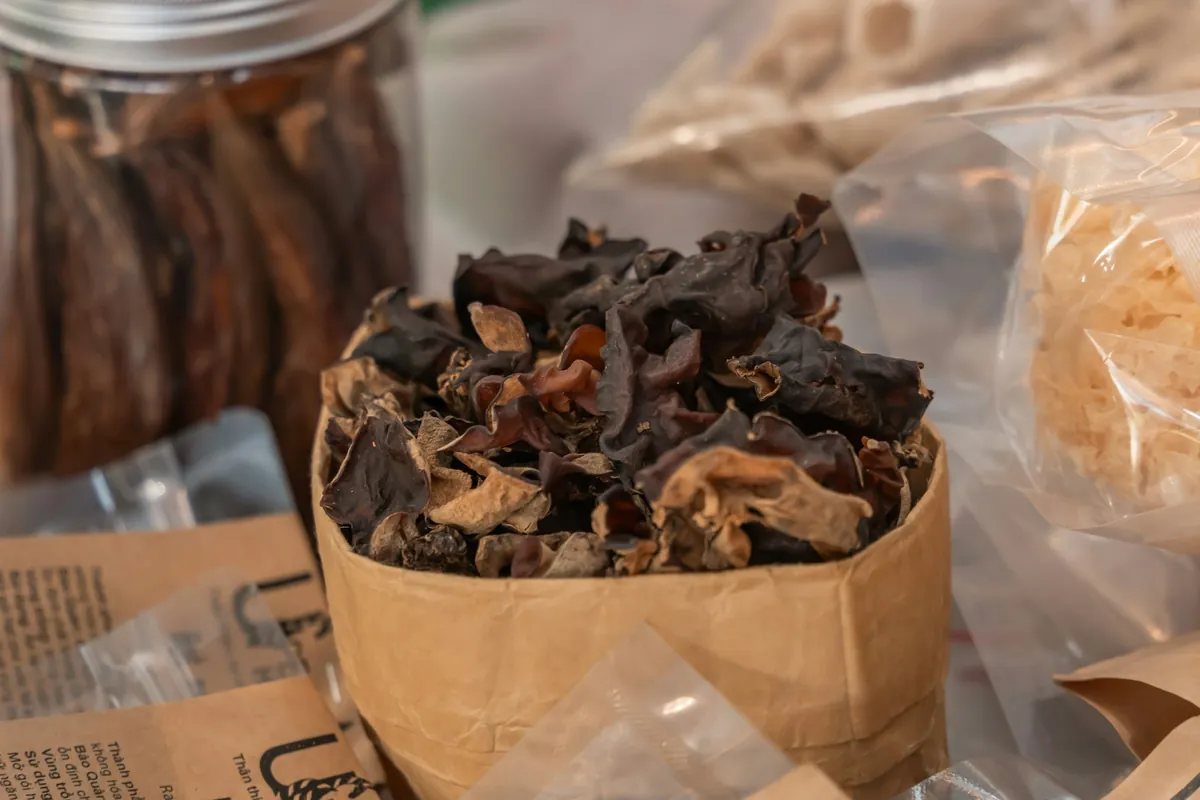 Dark mushrooms and shredded vegetables prepared for cooking